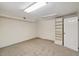 A finished room with neutral walls, carpet, and a book shelf at 3317 Harden Rd, Raleigh, NC 27607