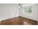 Bedroom with a window, ceiling fan, and hardwood floors offers natural light at 3317 Harden Rd, Raleigh, NC 27607