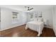 Bedroom with hardwood floors, a ceiling fan, and a large window for natural light at 3317 Harden Rd, Raleigh, NC 27607