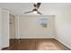 Bedroom with hardwood floors, closet, window, and a ceiling fan at 3317 Harden Rd, Raleigh, NC 27607