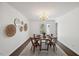 Dining room with hardwood floors, modern chandelier and neutral walls at 3317 Harden Rd, Raleigh, NC 27607