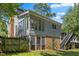 Charming two-story home featuring a sunroom, a deck, brick accents and a fenced yard at 3317 Harden Rd, Raleigh, NC 27607