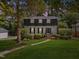 Charming two-story home features a landscaped yard and classic architectural details at 3317 Harden Rd, Raleigh, NC 27607
