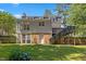 Rear exterior featuring sunroom, deck, brick accents and a well-maintained lawn at 3317 Harden Rd, Raleigh, NC 27607
