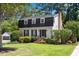 Charming two-story home with lush landscaping and a well-manicured lawn at 3317 Harden Rd, Raleigh, NC 27607