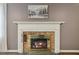 Close-up of traditional fireplace with brick surround, white mantle and hearth at 3317 Harden Rd, Raleigh, NC 27607