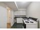A small kitchenette with white cabinets and a black countertop at 3317 Harden Rd, Raleigh, NC 27607