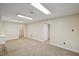 An empty living room with beige carpet, neutral walls and two doorways at 3317 Harden Rd, Raleigh, NC 27607