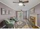 Cozy living room with fireplace, ceiling fan, hardwood floors and traditional furnishings at 3317 Harden Rd, Raleigh, NC 27607