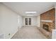 An empty living room with a red brick fireplace and a white mantle at 3317 Harden Rd, Raleigh, NC 27607