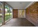 A screened-in porch with brick walls and an exterior view of the yard at 3317 Harden Rd, Raleigh, NC 27607