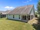 A view of the house from the backyard featuring a well-maintained lawn and a screened-in porch at 35 Clubhouse Dr, Youngsville, NC 27596