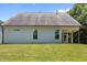 Backyard view of the house featuring a well-maintained lawn and an open patio at 35 Clubhouse Dr, Youngsville, NC 27596