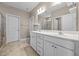 Bathroom featuring double sinks, tile floors, a glass shower, and toilet with a doorway for privacy at 35 Clubhouse Dr, Youngsville, NC 27596