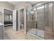 Spacious bathroom featuring a glass shower, tile flooring and an adjoining toilet with doorway for privacy at 35 Clubhouse Dr, Youngsville, NC 27596