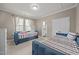 Bedroom featuring two twin beds, multiple windows and doorway to private toilet at 35 Clubhouse Dr, Youngsville, NC 27596