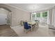 Elegant dining area with a wooden table, comfortable chairs, and large windows for natural light at 35 Clubhouse Dr, Youngsville, NC 27596