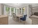 Elegant dining room with large windows, natural lighting, and neutral color palette at 35 Clubhouse Dr, Youngsville, NC 27596