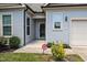 Inviting front entrance with a well-kept lawn and tasteful landscaping, complete with security sign at 35 Clubhouse Dr, Youngsville, NC 27596