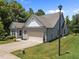Exterior of house with a well-kept lawn, a two car garage, and a neatly manicured landscape at 35 Clubhouse Dr, Youngsville, NC 27596