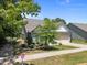 Charming single-Gathering home featuring a well-maintained lawn and attached garage on a sunny day at 35 Clubhouse Dr, Youngsville, NC 27596
