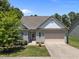 Charming single-Gathering home with a well-maintained lawn and a two-car garage with a concrete driveway at 35 Clubhouse Dr, Youngsville, NC 27596