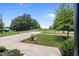 Spacious front yard with a concrete driveway and lush green grass, offering a welcoming curb appeal at 35 Clubhouse Dr, Youngsville, NC 27596