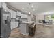 Open-concept kitchen featuring an island with bar seating, stainless steel appliances, and white cabinetry at 35 Clubhouse Dr, Youngsville, NC 27596