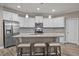 Well-lit kitchen features a center island, stainless steel appliances, and granite countertops at 35 Clubhouse Dr, Youngsville, NC 27596