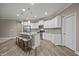 Bright kitchen with white cabinets, stainless steel appliances, granite countertops, and island with bar stools at 35 Clubhouse Dr, Youngsville, NC 27596