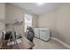 Laundry room featuring a work station, a shelf and a new, front loading washer and dryer at 35 Clubhouse Dr, Youngsville, NC 27596