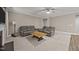 Comfortable living room with plush gray seating, neutral carpeting, and a ceiling fan at 35 Clubhouse Dr, Youngsville, NC 27596