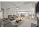 Spacious open-concept living room featuring a fireplace, neutral carpet, and access to the kitchen at 35 Clubhouse Dr, Youngsville, NC 27596