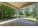 Spacious covered patio with views of the green backyard and surrounding trees at 35 Clubhouse Dr, Youngsville, NC 27596