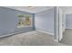 Cozy bedroom with plush carpeting, neutral paint, and a large window for natural light at 3604 Rivermist Dr, Raleigh, NC 27610