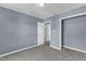 The carpeted bedroom with blue walls offers a ceiling fan and access to an adjacent closet and room at 3604 Rivermist Dr, Raleigh, NC 27610