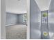This spacious bedroom features neutral carpet, blue walls, and a window with a view of the outdoors at 3604 Rivermist Dr, Raleigh, NC 27610