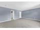 A spacious bedroom features neutral carpet, blue walls, and access to the bathroom and walk-in closet at 3604 Rivermist Dr, Raleigh, NC 27610
