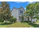 Beautiful two-story home with a green lawn, mature trees, and charming curb appeal at 3604 Rivermist Dr, Raleigh, NC 27610