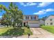 Lovely two-story home with a well-maintained lawn, mature tree, and a two-car garage at 3604 Rivermist Dr, Raleigh, NC 27610