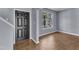 Inviting foyer features wood-look flooring, neutral paint, and a black front door at 3604 Rivermist Dr, Raleigh, NC 27610
