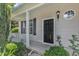 Charming front porch with white railings, black front door, and neat landscaping details at 3604 Rivermist Dr, Raleigh, NC 27610