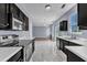 The kitchen features stainless appliances and views into the living room at 3604 Rivermist Dr, Raleigh, NC 27610
