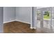 Open living space with wood-look floors, neutral gray walls, and lots of natural light at 3604 Rivermist Dr, Raleigh, NC 27610