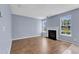Living room features a fireplace with mantle, wood-look flooring, and bright natural light at 3604 Rivermist Dr, Raleigh, NC 27610