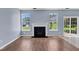 Bright living room showcases fireplace, patio access, and wood-look flooring at 3604 Rivermist Dr, Raleigh, NC 27610