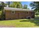 Back exterior of brick home shows door, windows, and condenser at 37 Weeping Willow Ln, Lillington, NC 27546