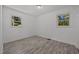 Bright bedroom features gray wood-look floors and two windows at 37 Weeping Willow Ln, Lillington, NC 27546