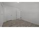 Bedroom includes gray wood-look floors, closet and access to bathroom at 37 Weeping Willow Ln, Lillington, NC 27546