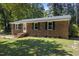 Cozy brick home with a well-kept lawn, black shutters, and a welcoming front entrance at 37 Weeping Willow Ln, Lillington, NC 27546